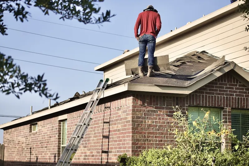 Professional roofer working on a residential roof in Monee